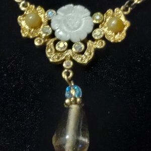 1928 gold tone necklace with rhinestone, pearl medalian